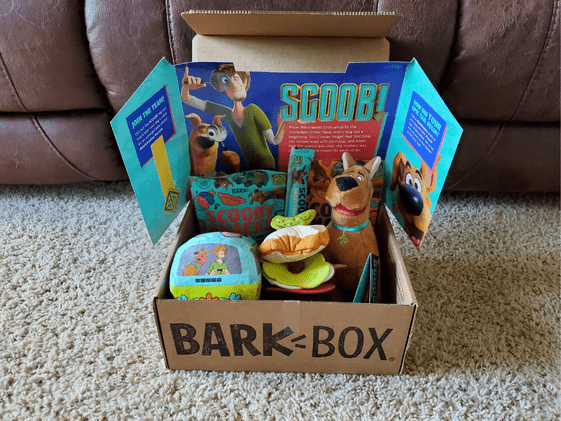 A Bark Box with Scooby Doo themed toys and treats.