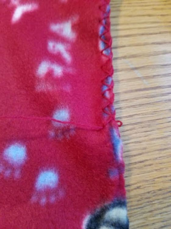 Pulling the blanket stitch out of the fleece throw