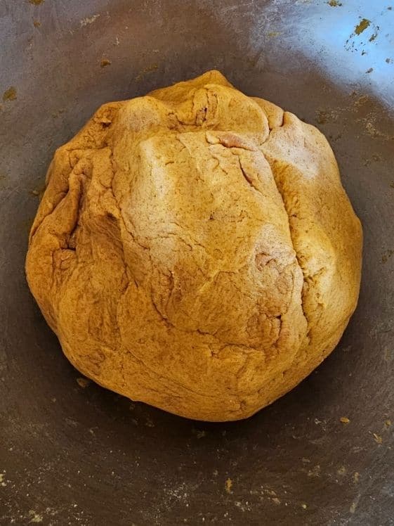 Peanut butter pumpkin treat dough in a large ball shape.