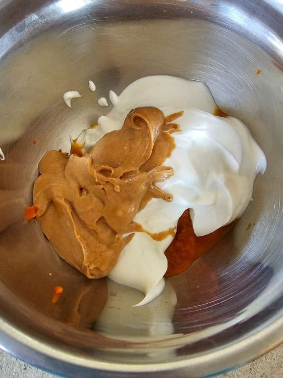 Peanut butter, Greek yogurt, and pumpkin puree in a bowl.