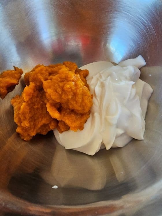 Pumpkin puree and Greek yogurt in a mixing bowl.