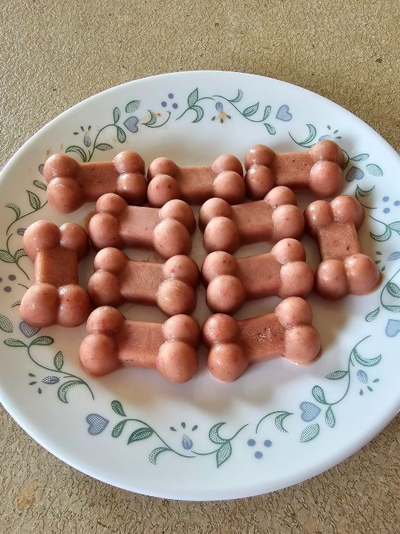 Small bone shaped frozen strawberry banana dog treats.