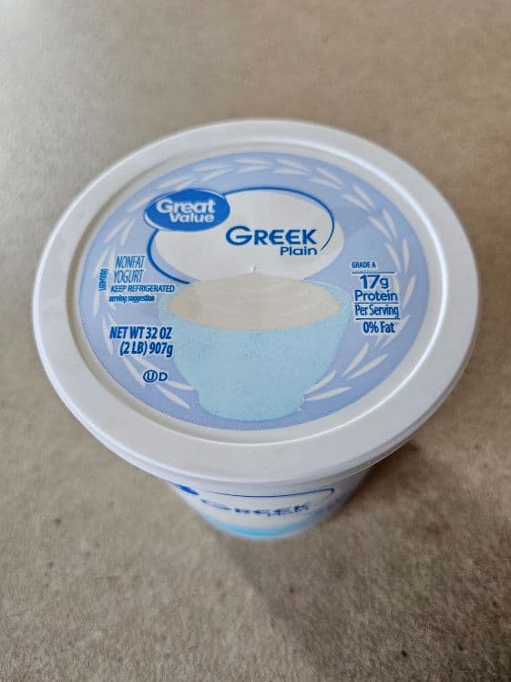 A container of plain Greek yogurt.