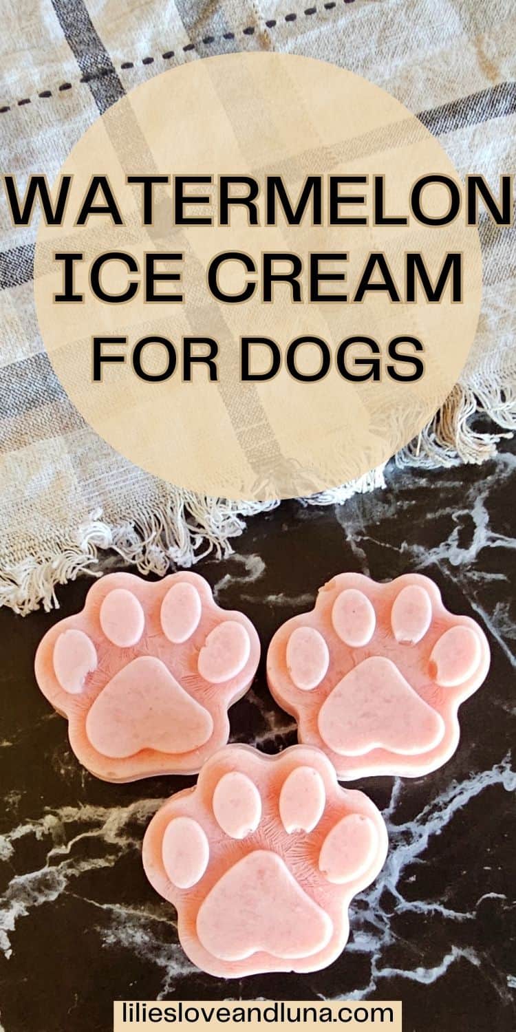 Three paw-shaped frozen watermelon ice cream treats for dogs are displayed on a dark surface, accompanied by a patterned cloth in the background.