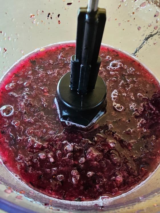 Watermelon and blueberries puree in a food processor.