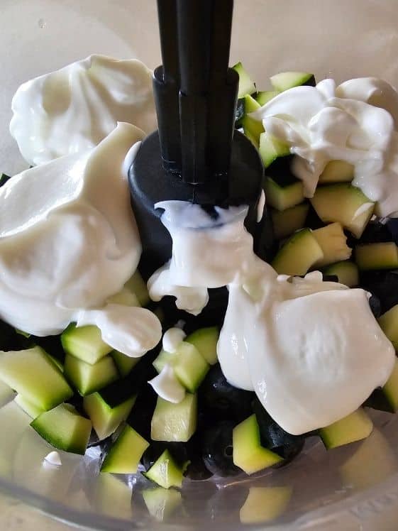 Zucchini, blueberries, and Greek yogurt in a food processor.