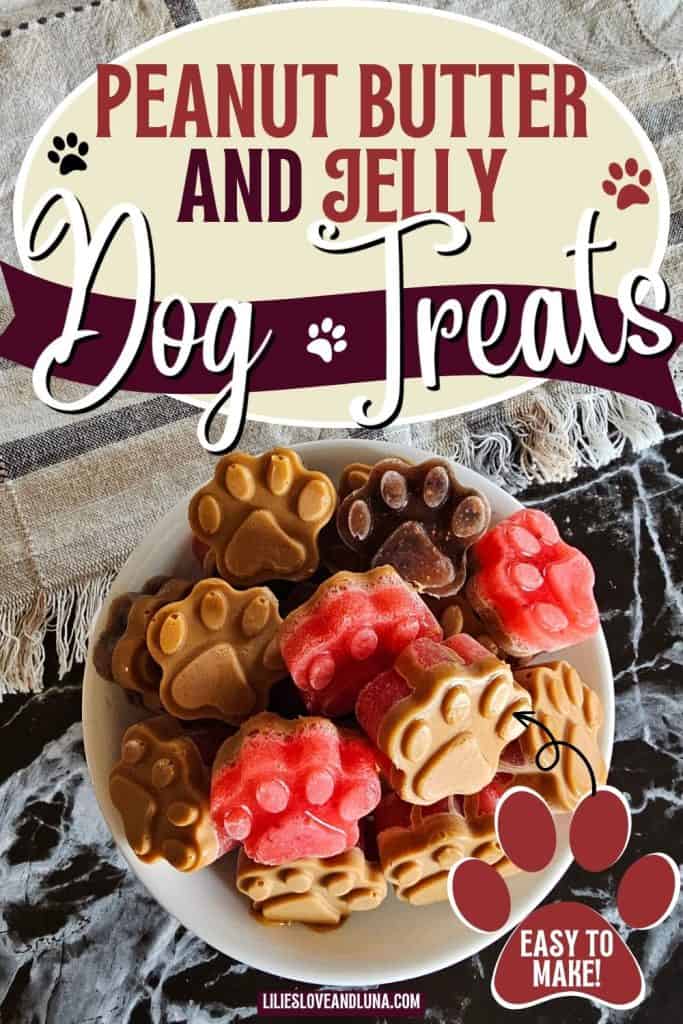 A bowl of homemade peanut butter and jelly dog treats shaped like paw print molds sits on a counter.