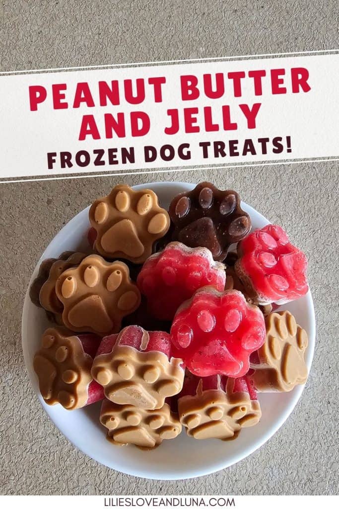 A bowl filled with homemade peanut butter and jelly frozen dog treats shaped like paw prints, featuring a mix of brown and red colors.