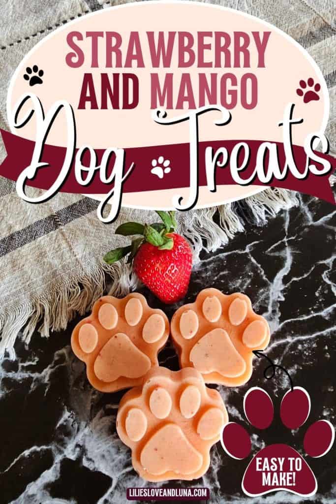 A close-up image of three paw-shaped strawberry and mango frozen dog treats, accompanied by a fresh strawberry and a decorative banner indicating they are easy to make.