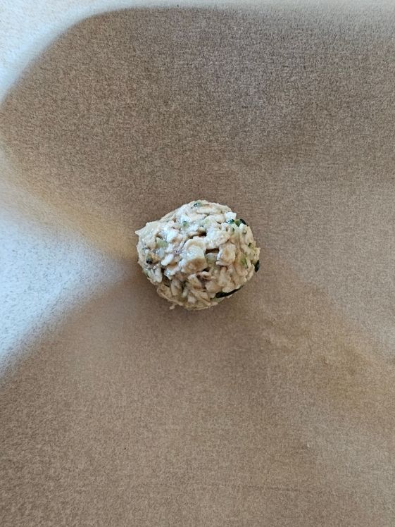 A zucchini banana ball on a cookie sheet.