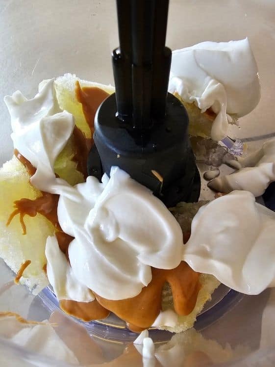 Shredded frozen zucchini, peanut butter, and Greek yogurt in a food processor.