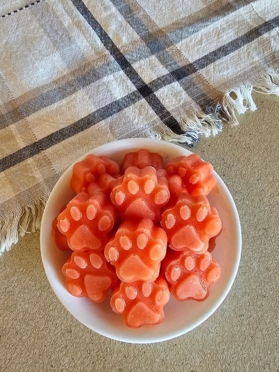 Paw shaped strawberry mango pineapple frozen dog treats.